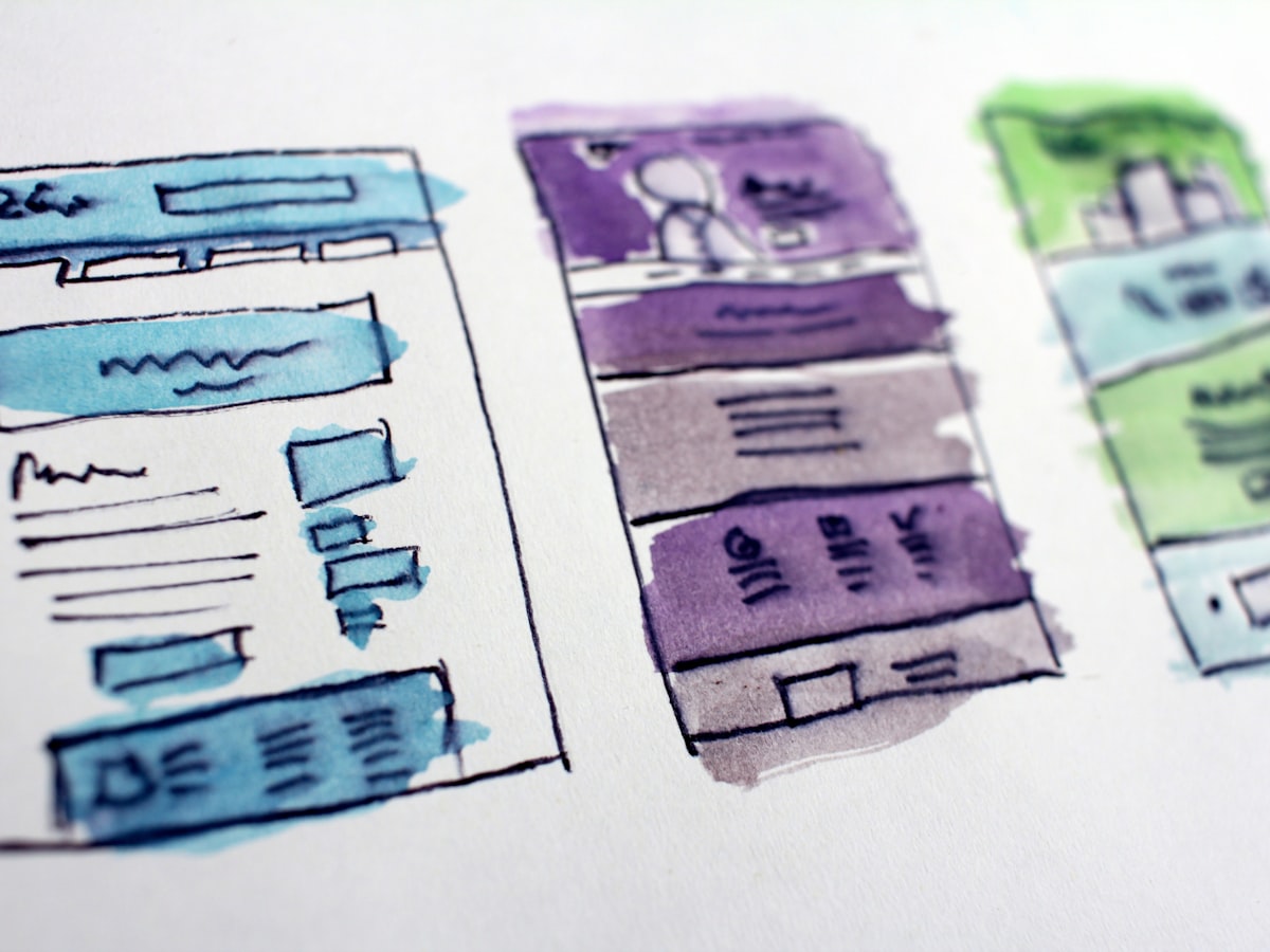 Hand-drawn watercolor wireframe sketches of website page layouts